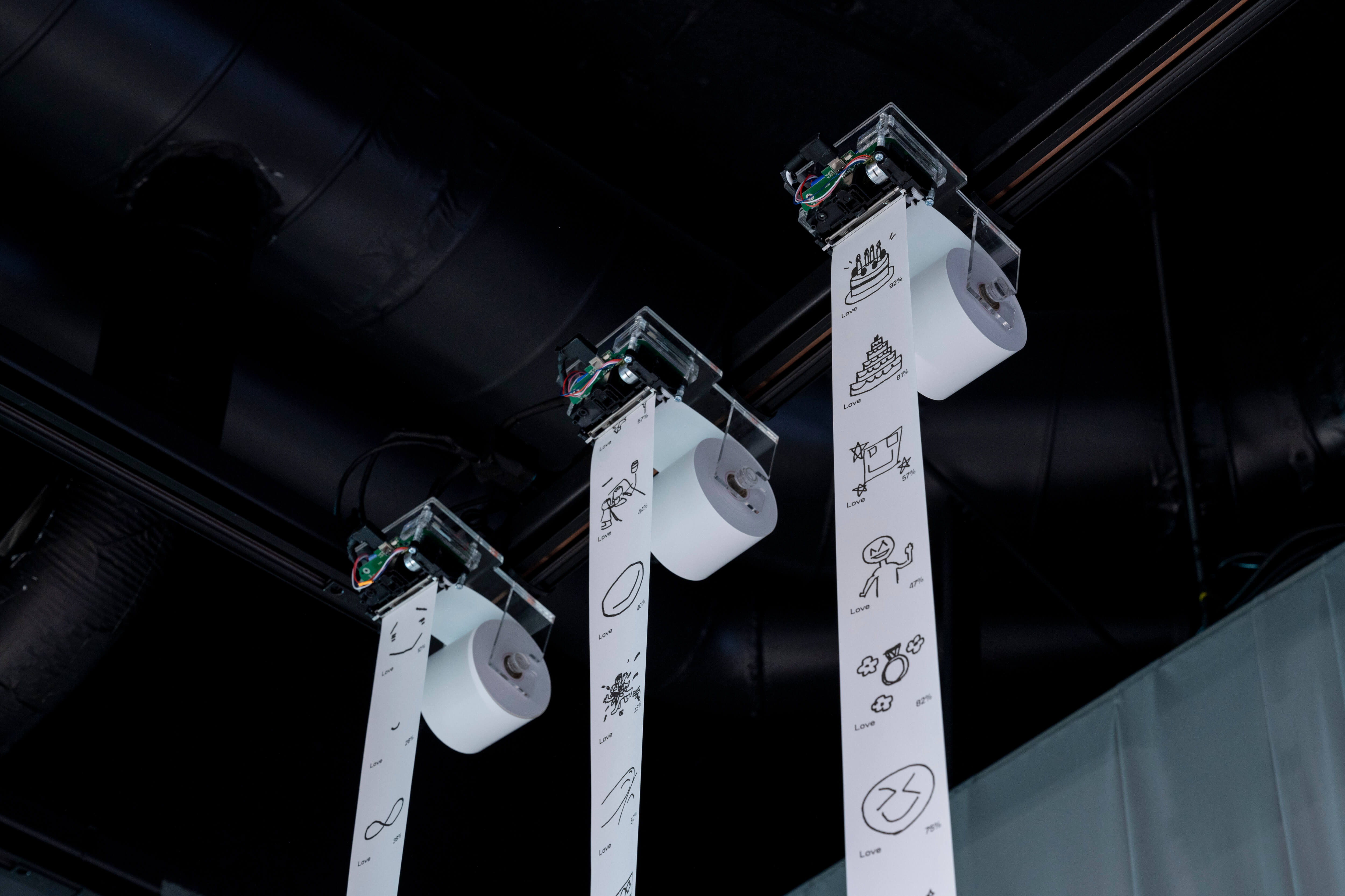 Receipt printers hanging down from the ceiling.